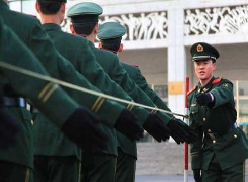 soldiers learn to march with their arms wired and attached to poles