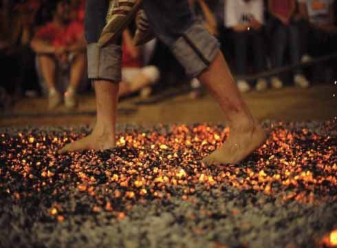 Carrying pregnant wife over burning coal in China
